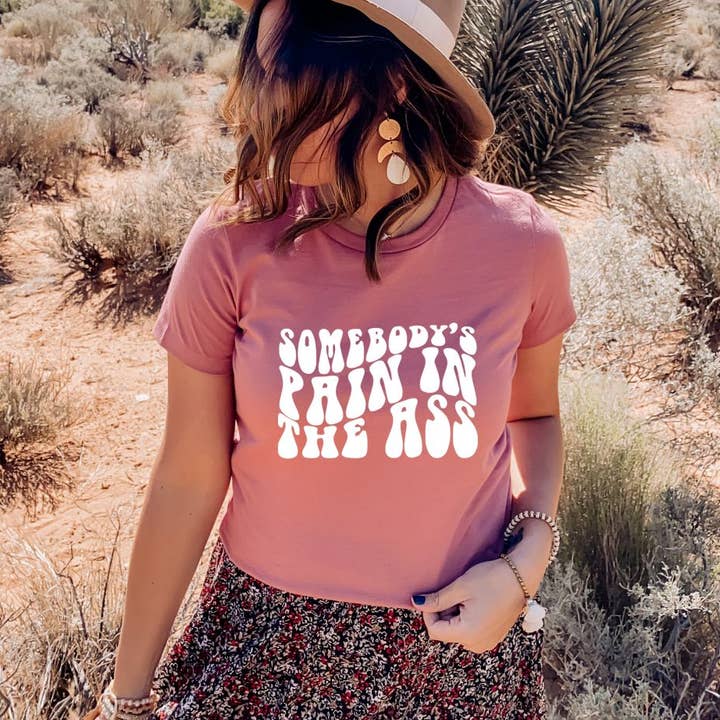 Somebody's Pain In The Ass T-shirt | Graphic Shirts for wholesale by KM Clothing