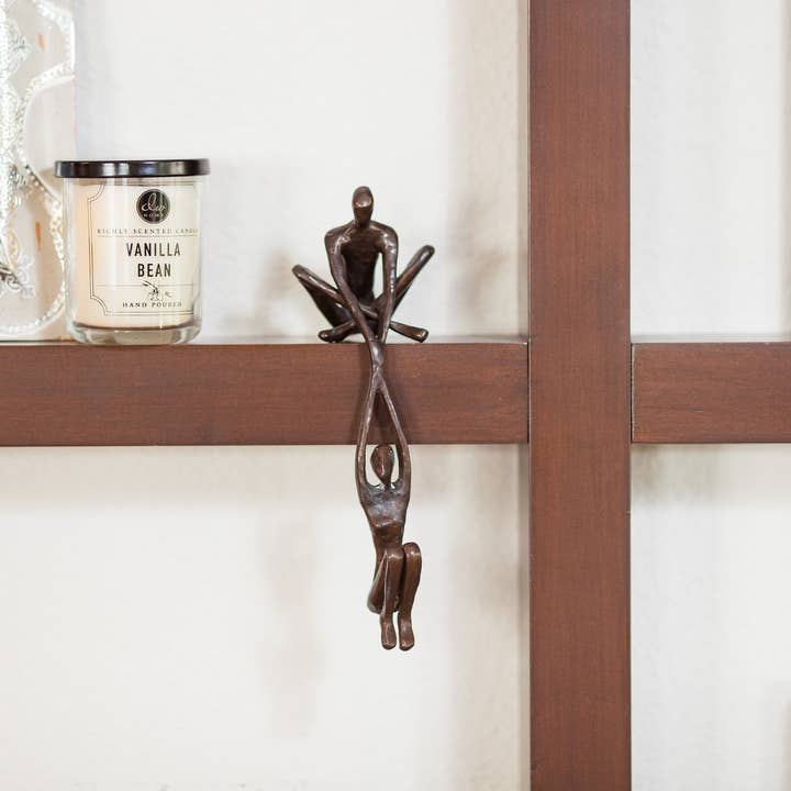 Danya B - Wholesale Sculpture - Man Lifting Woman from Ledge Bronze Sculpture3