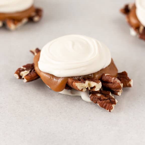 White Chocolate Pecan Paws / 4lb. Case for wholesale by Maggie Lyon Chocolatiers