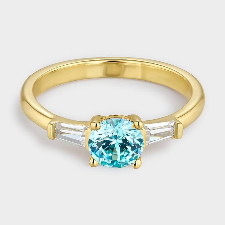 Trio ring with central zirconia blue aquamarine gold plating for wholesale by Itemporality