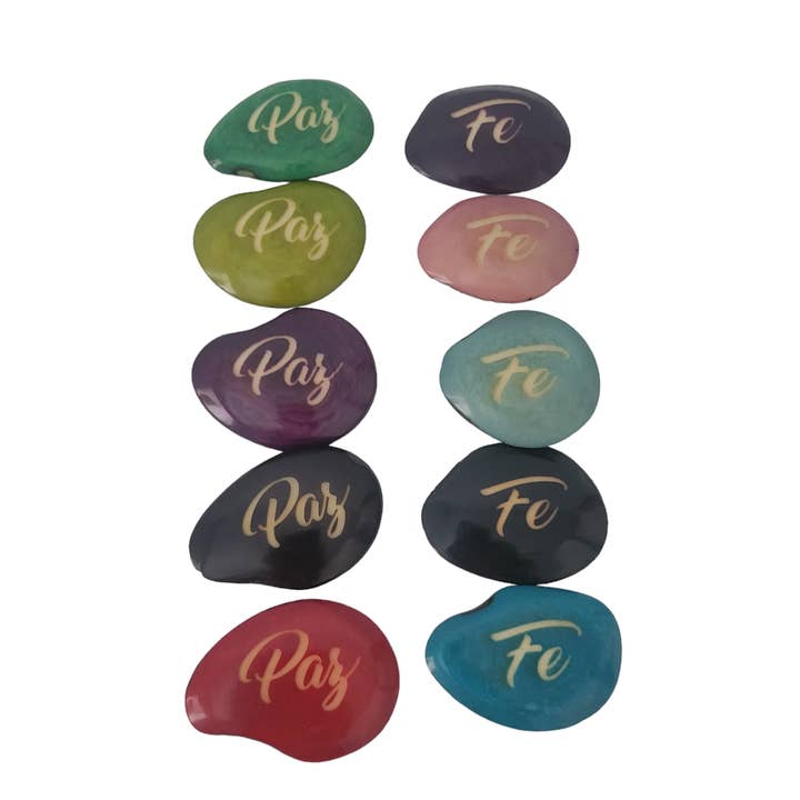 Multi Colored Faith engraved riverstones tagua nuts in Spanish for wholesale on Faire
