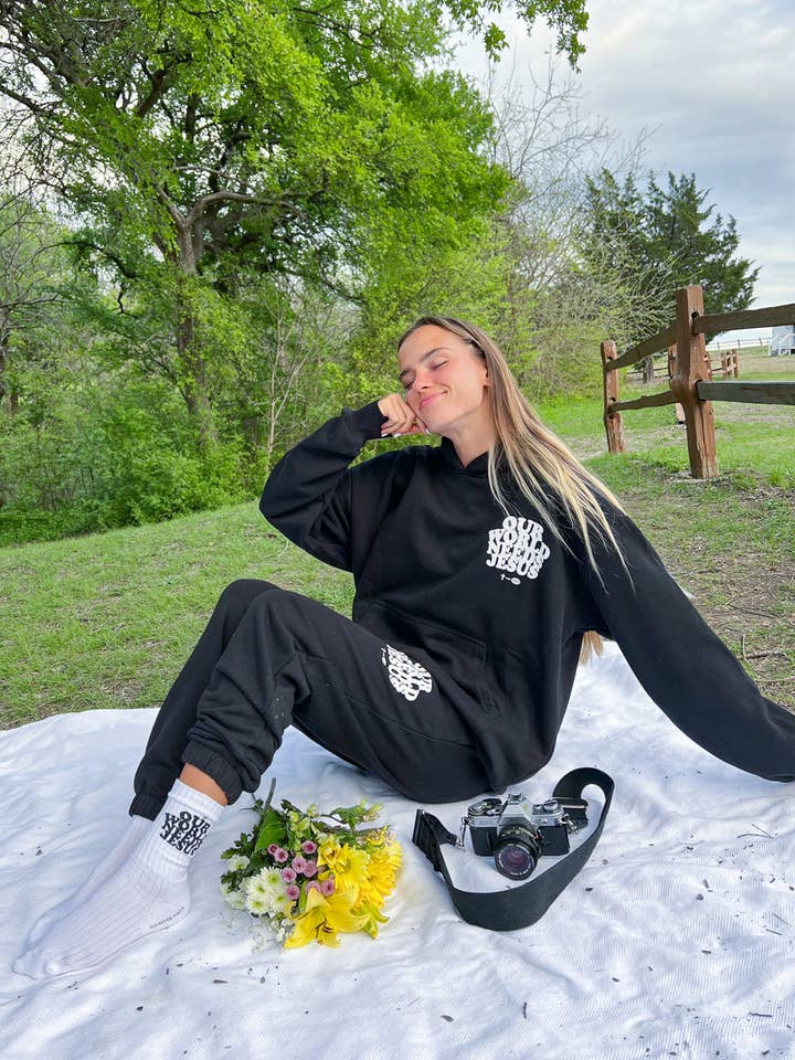 Our World Needs Jesus Black Unisex Sweatpant for wholesale by Elevated Faith