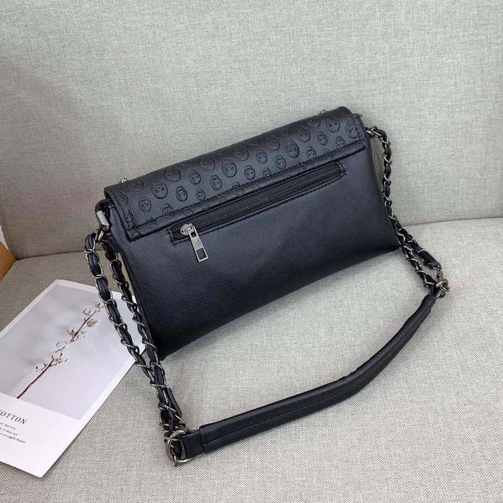 Black Embossed Riveted Skulls Shoulder Bag for wholesale on Faire6