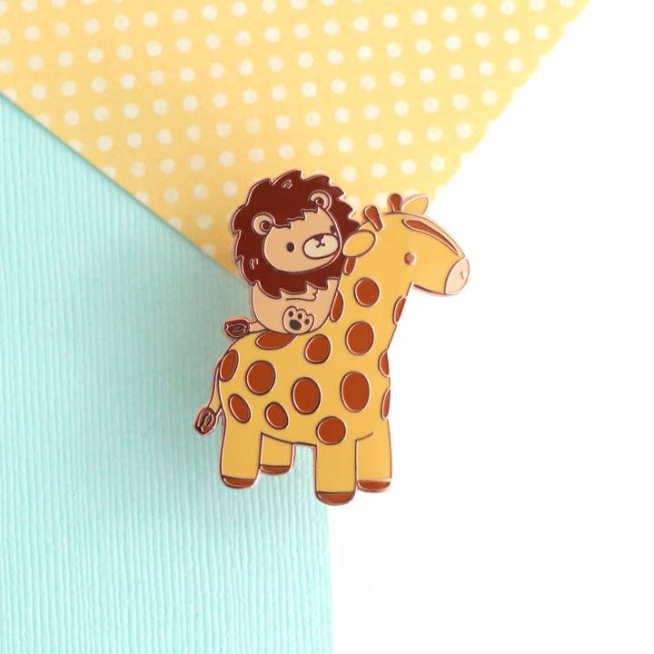 Lion Riding a Giraffe Enamel Pin for wholesale by Wild Whimsy Woolies