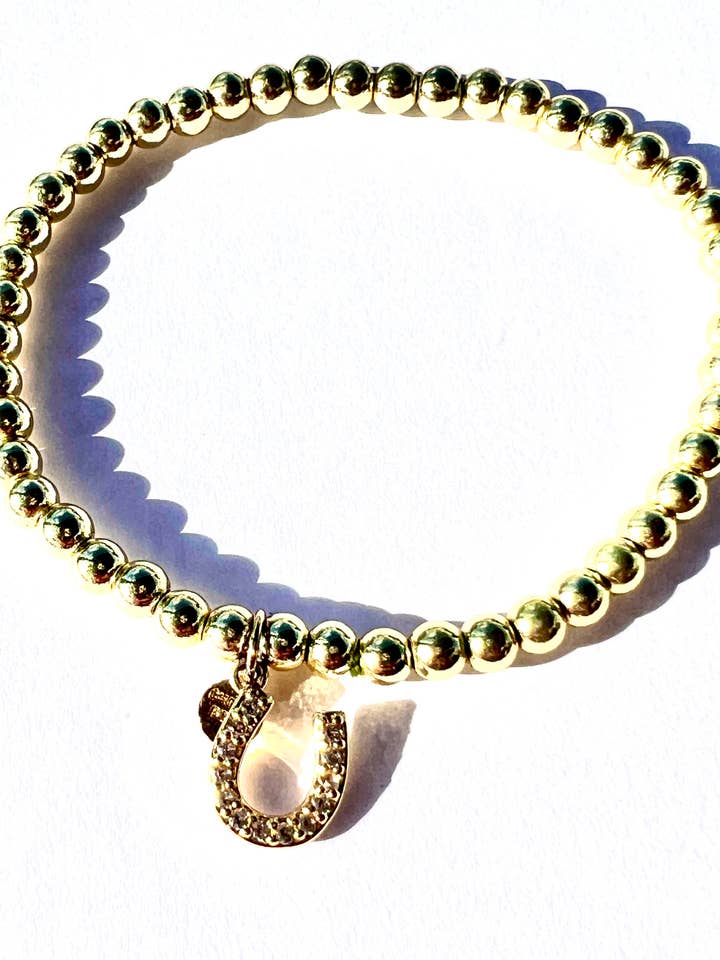 KICK | Gold stretch bead bracelet with CZ horseshoe charm for wholesale by CHEEKYBOOM