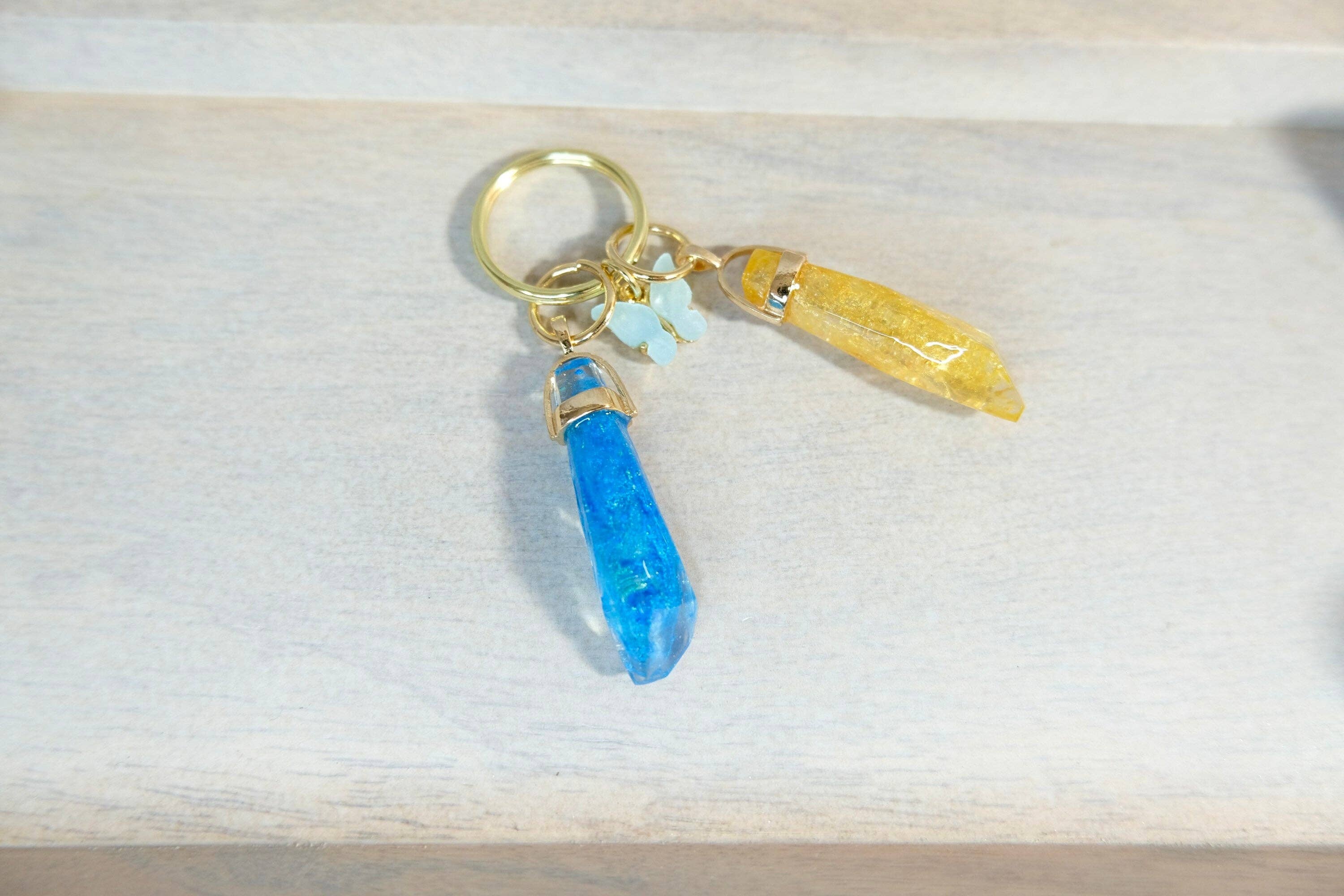 BlueButterflyBazaar - Wholesale Keychain - Women's - Yellow and Blue Reylo Ben Solo and Rey and Blue Butterfly Kyber Crystal keychain Star Wars, unique gift, collectable.