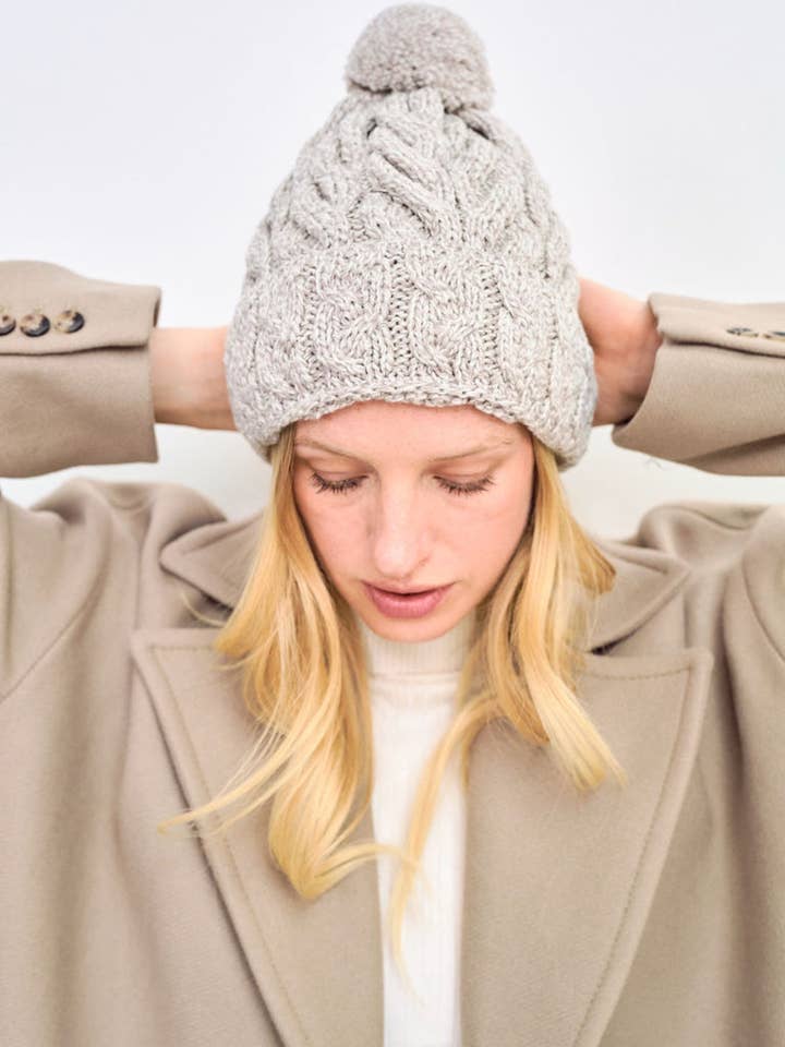 Clifden Cable Aran Hat with Pom Poms - Oat for wholesale by Aran Woollen Mills