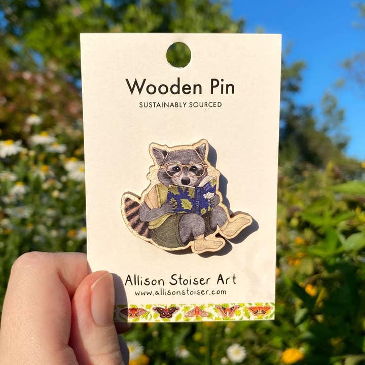Bookish Raccoon Wooden Pin (Sustainably Sourced) for wholesale by Allison Stoiser Art
