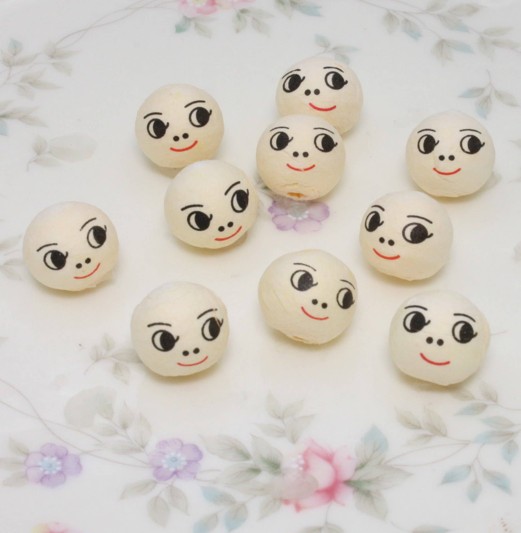 Doll Heads - 1/2" Spun Cotton with Faces - Set of 10 for wholesale on Faire5