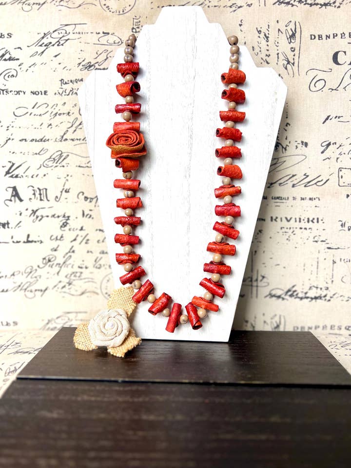 Orange flower necklace Adjustable cord Wearable art Handmade statement necklace Bold necklace made with orange peel and acai seeds for wholesale by Galapagos Tagua