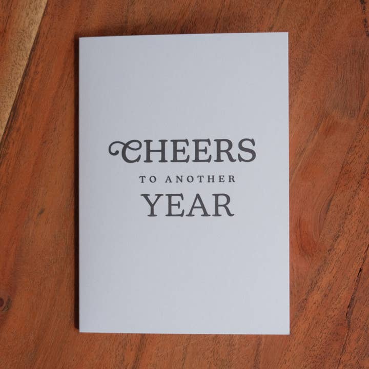 Cheers to Another Year Greeting Card for wholesale by Dugout Paper Co.