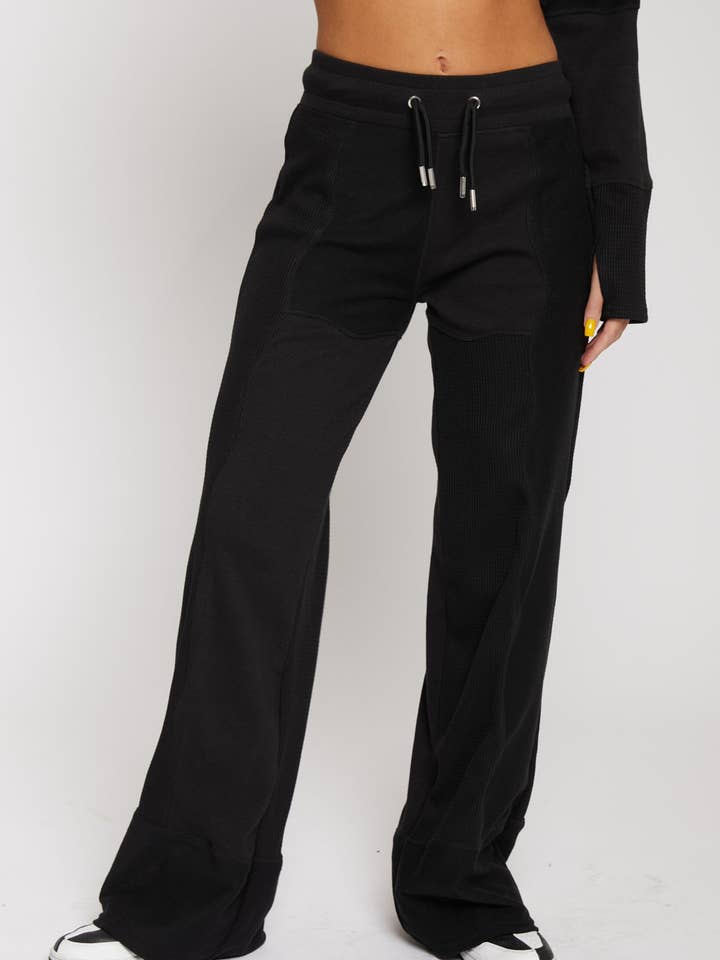 JOGGINGS AMPLES MIXTES - NOIR pour la vente par HERMAN & CO