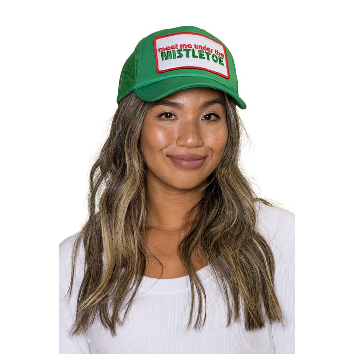 Meet Me Under The Mistletoe Trucker Hat in Green for wholesale on Faire1