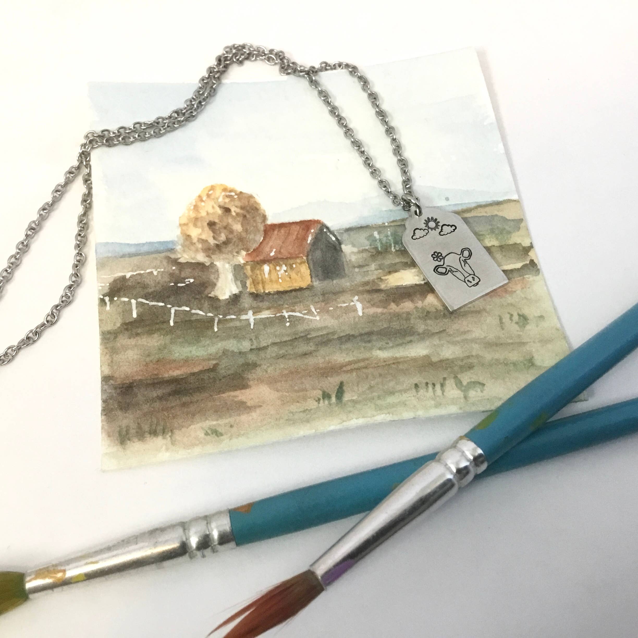 Jamie Haley Designs - Wholesale Pendant/Charm Necklace - Cow on cloudy day, cattle ear tag style pendant2