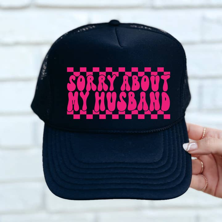 Sorry About My Husband DTF Printed Black Trucker Hat/Pink Text for wholesale by Southern Attitude Designs Inc