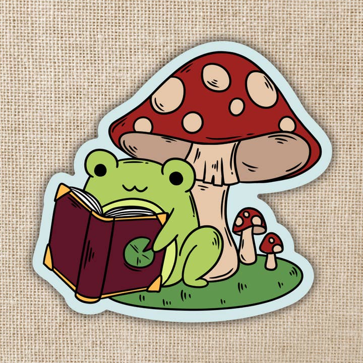 Frog Reading Under Toadstool Sticker for wholesale by Kingdom of Threads
