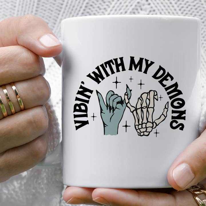 Vibin' With My Demons Funny Cool Skeleton Hand Coffee Mug for wholesale by Sister Ray