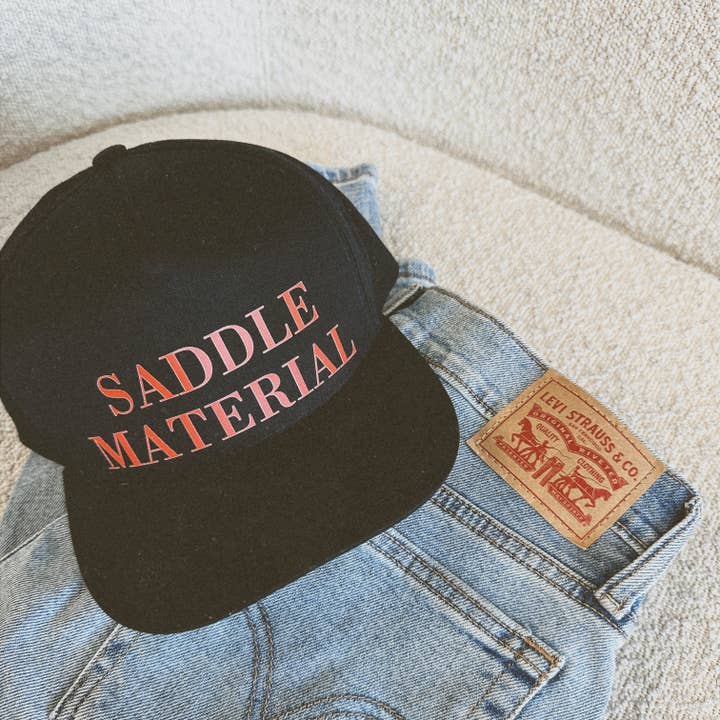 SADDLE MATERIAL TRUCKER HAT for wholesale by Wild & Wanted
