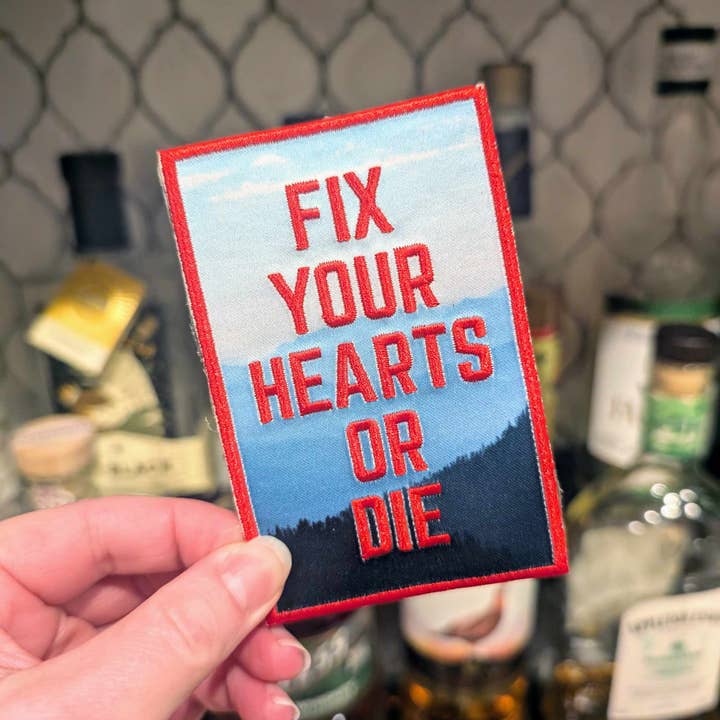 Fix Your Hearts iron-on patch (Red Room version) for wholesale by Cunning Linguist Co.