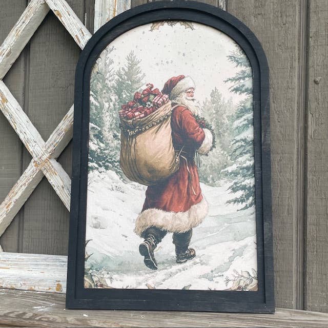 LAND OF COTTON – wholesale Christmas Wall Art – Snowy Forest w/Santa Carrying Sack Print in Med Arch Frame 1