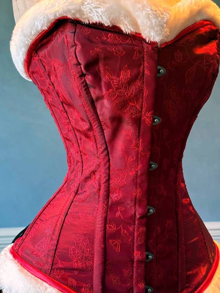 Red brocade with white fur affordable Santa Christmas corset. Corset is made personally according to your measurements. for wholesale by corsettery