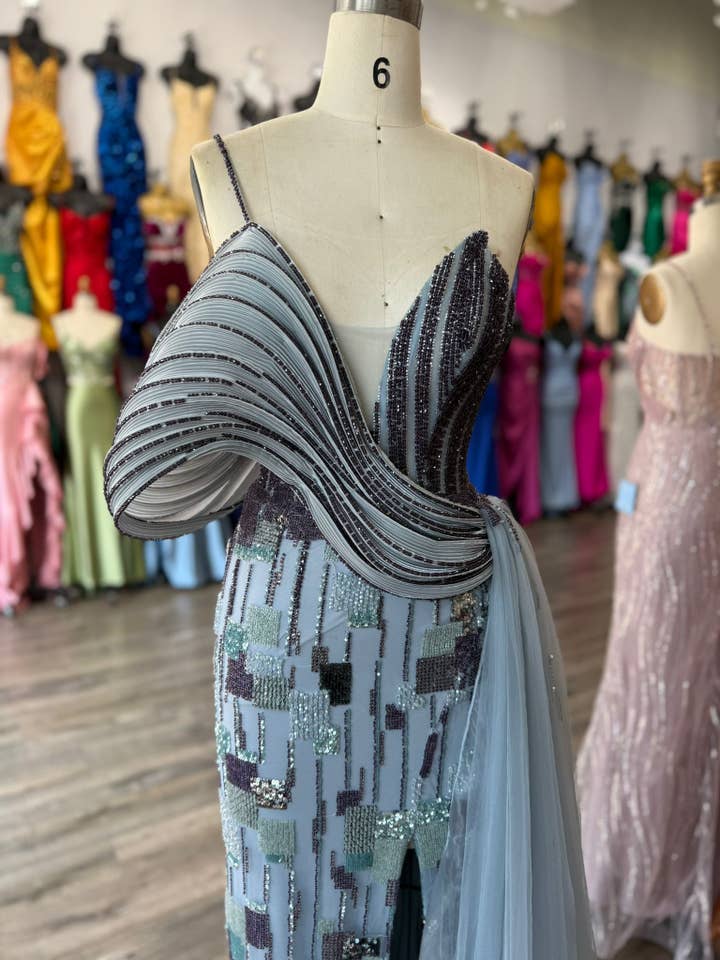 DUSTY BLUE Asymmetrical neckline, off the shoulder, long cape like slee for wholesale on Faire3