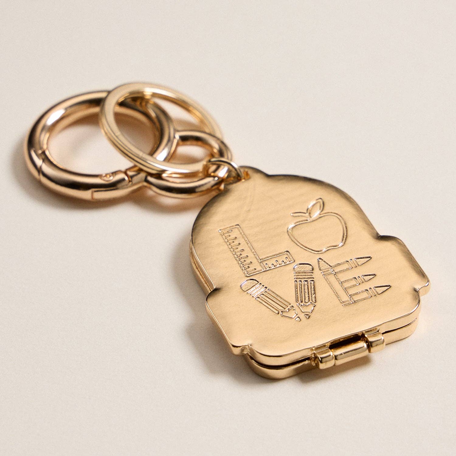 IV Gold Backpack Locket Keychain with School Supply Icons for wholesale on Faire2