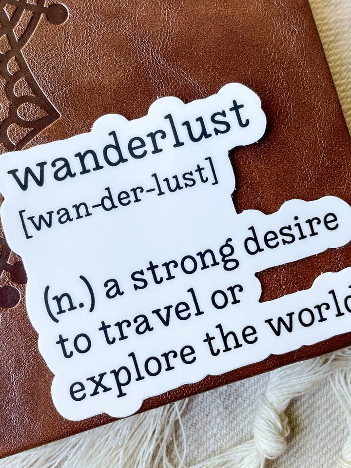 Wanderlust Definition Waterproof Sticker for wholesale by Meaggie Moos