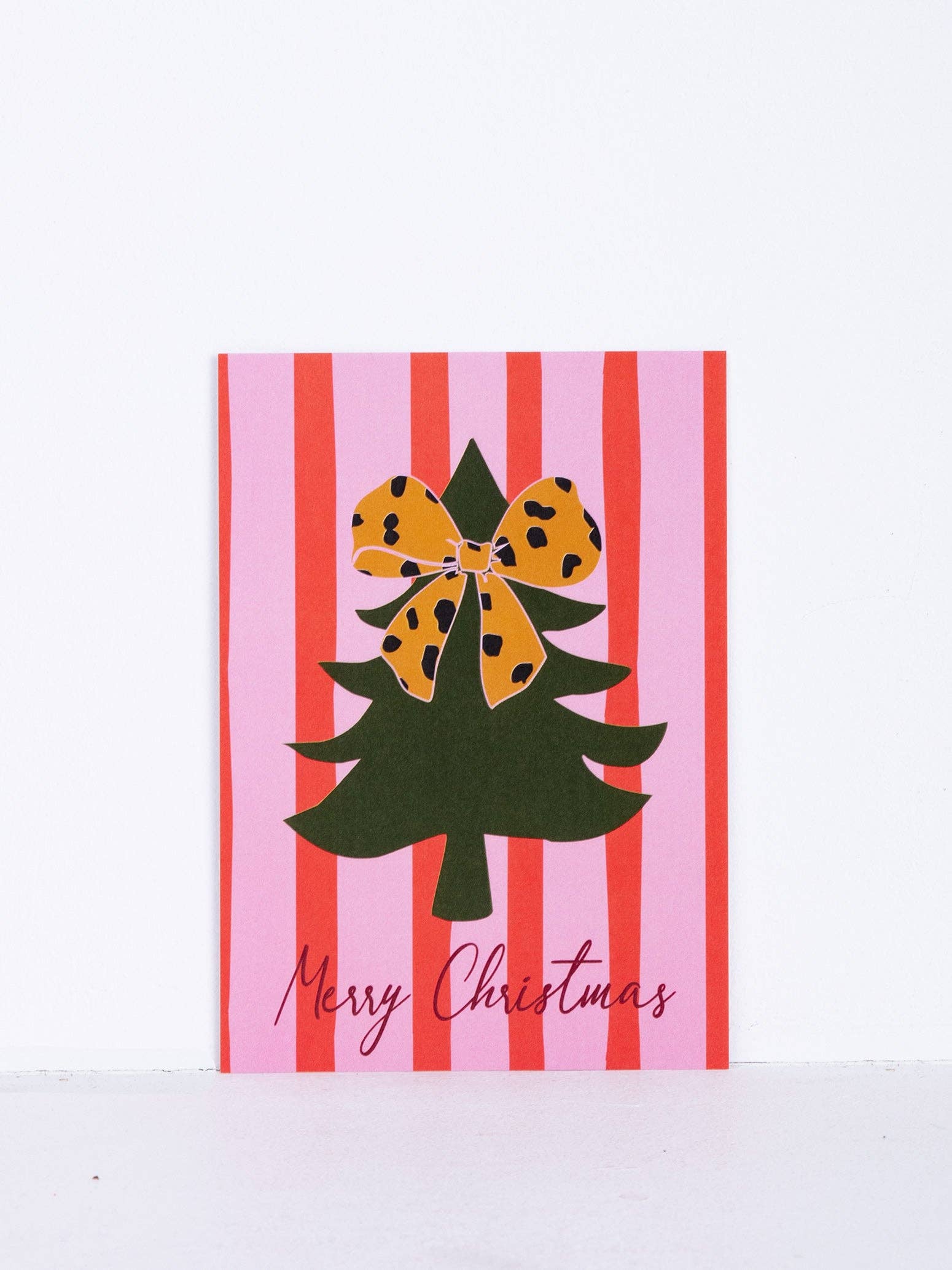 orange coopz Christmas card - Christmas tree with pink/red bow for wholesale on Faire
