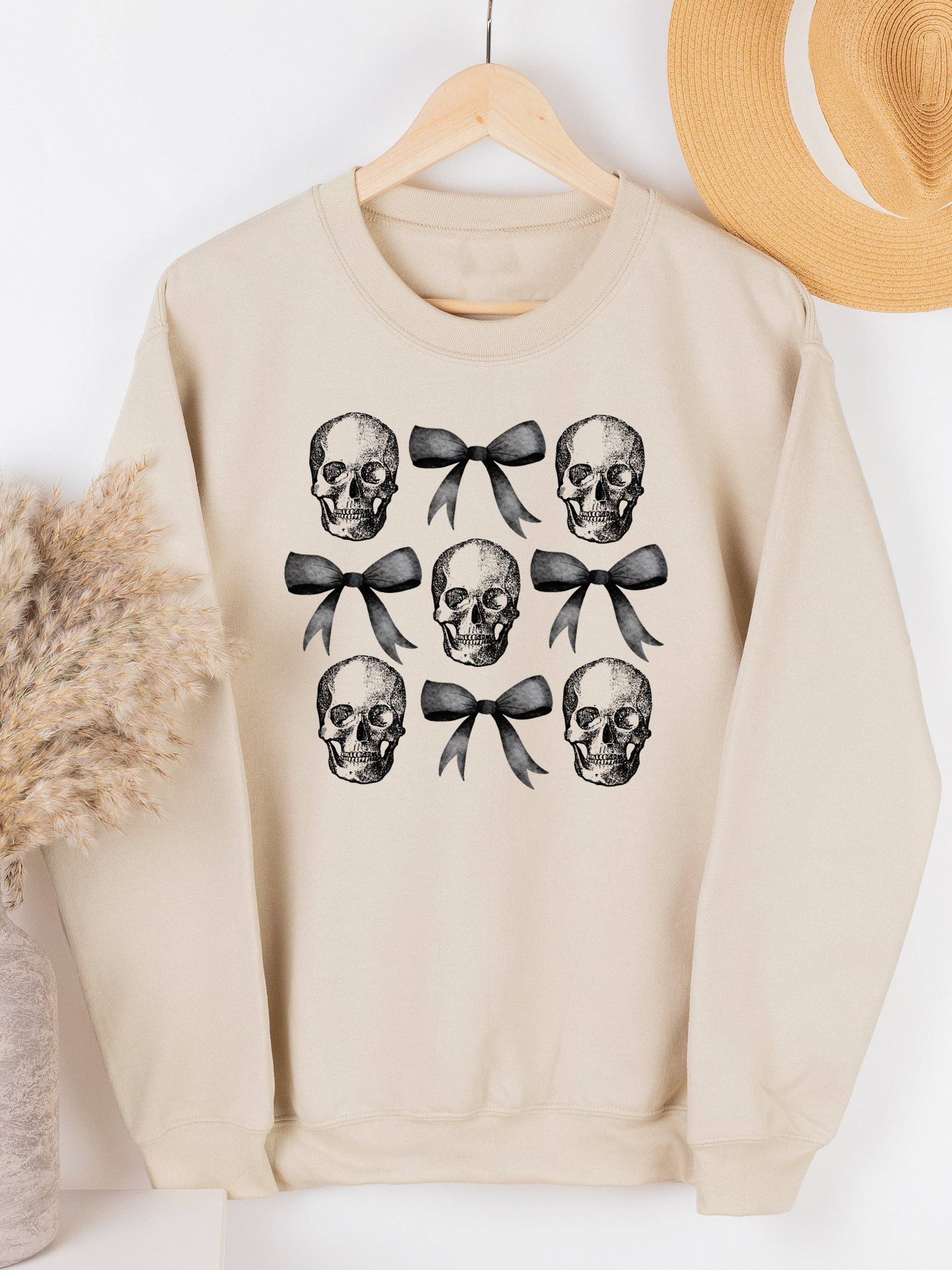 Tickled Teal – Großhandel Sweatshirt mit Grafikdruck – Damen – Sweatshirt mit Totenkopf- und Bogenmotiv0