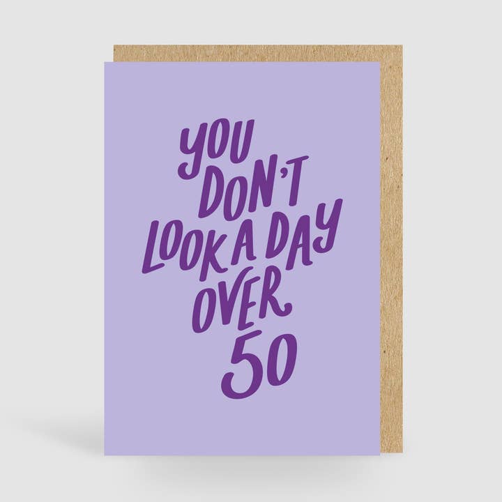 You Don't Look A Day Over 50! Lilac Birthday Card for wholesale by Jane Katherine Houghton Designs
