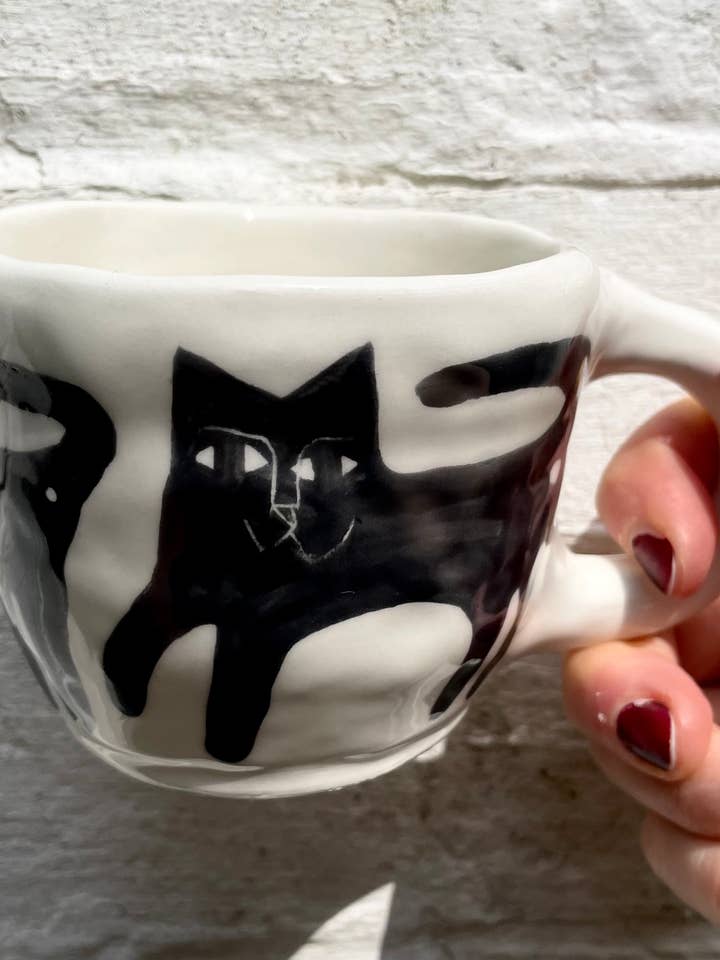 Ceramic Mug, illustrated with black cats for wholesale by Anna Soba