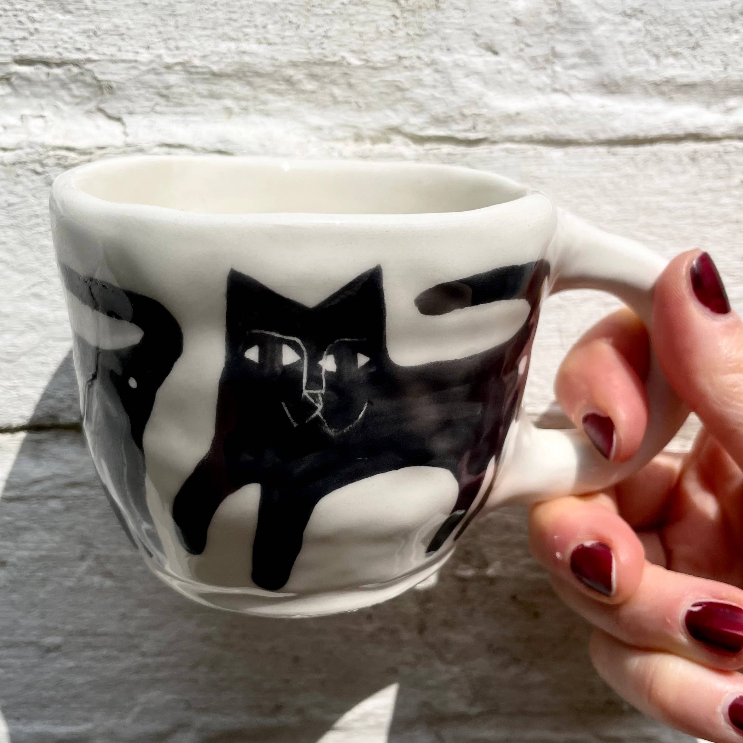Ceramic Mug, illustrated with black cats for wholesale by Anna Soba