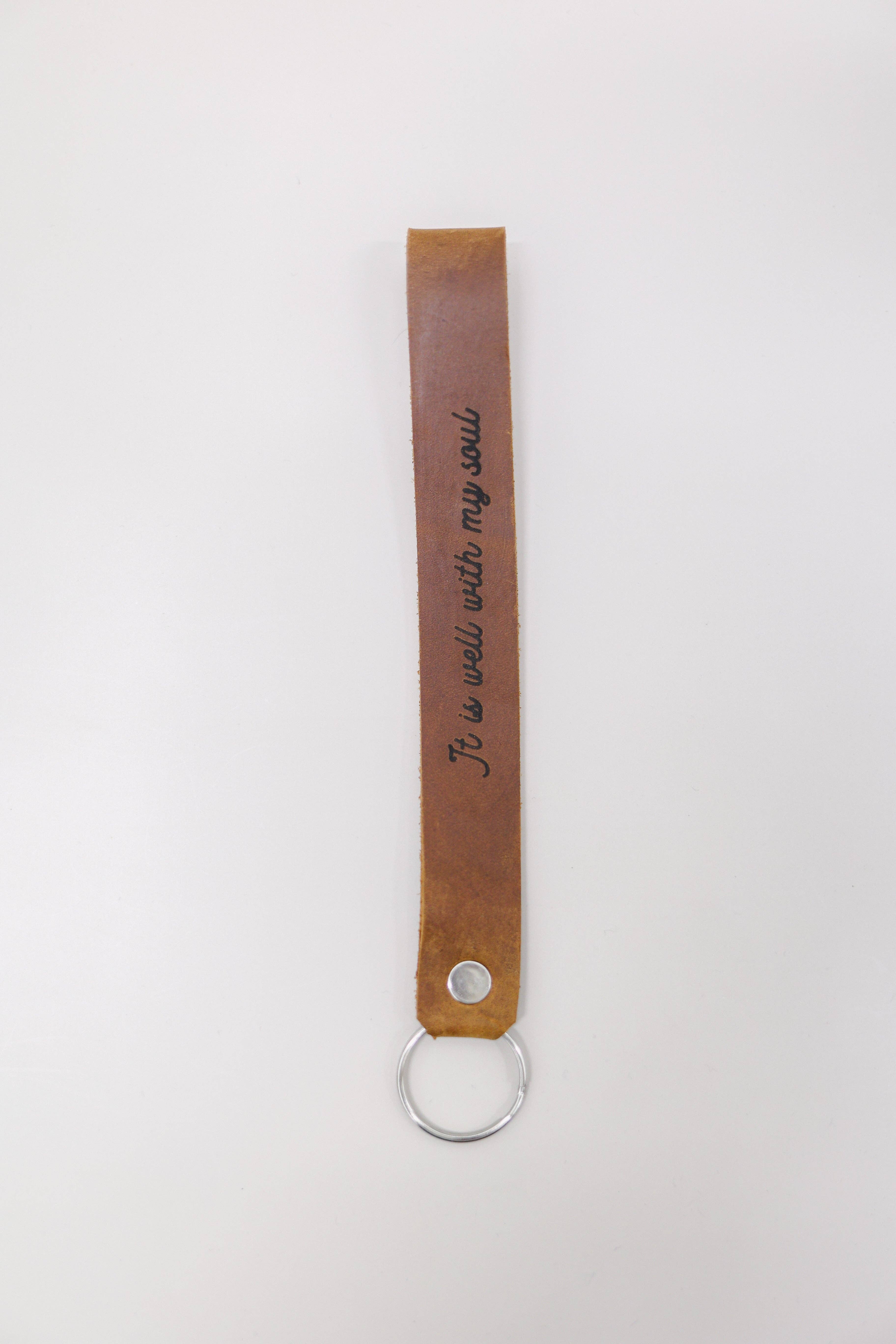 Jubilee Trading Co.  |  Ethical Trade Decor + Accessories - Wholesale Keychain - Unisex - It Is Well With My Soul Wristlet Engraved Leather3
