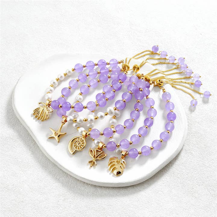 Light Purple And Light Silver Pearls Bracelet With Golden Beads In Different Hawaiian Charms for wholesale by S&T Collections