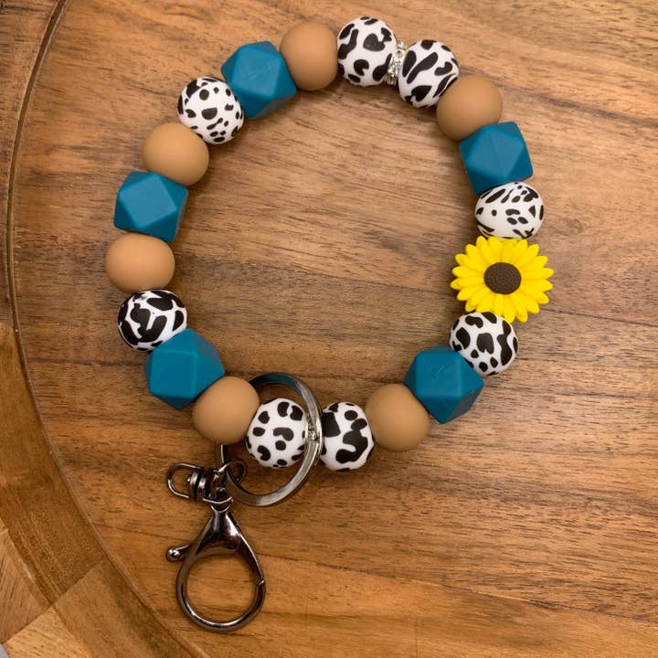 Blue Sunflower Cow Print Wristlet for wholesale by Wildthings & Wildflowers