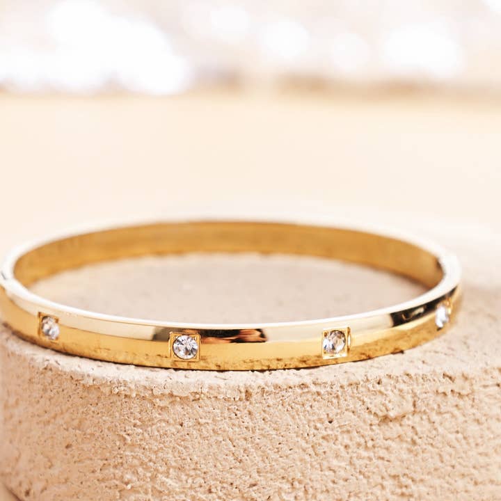 Bracelet en acier titane doré avec 4 pierres étincelantes pour la vente par Revelari