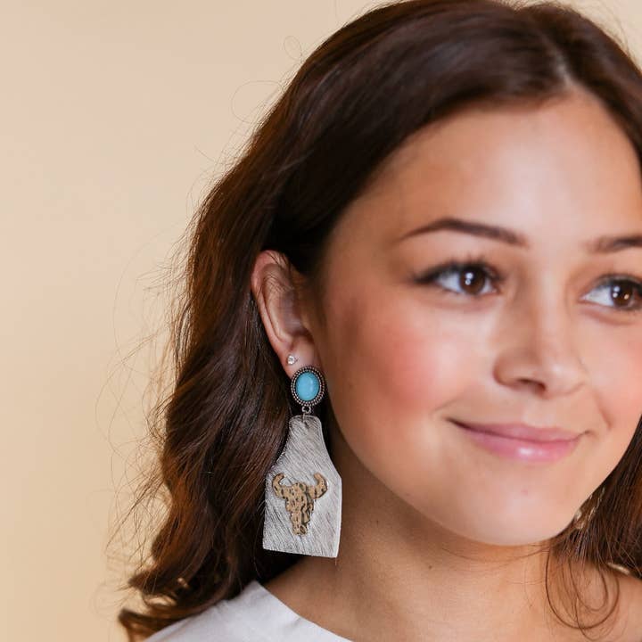 TAKE A NUMBER COWBOY WHITE COWHIDE SILVER COWSKULL STUD EARRINGS for wholesale on Faire0