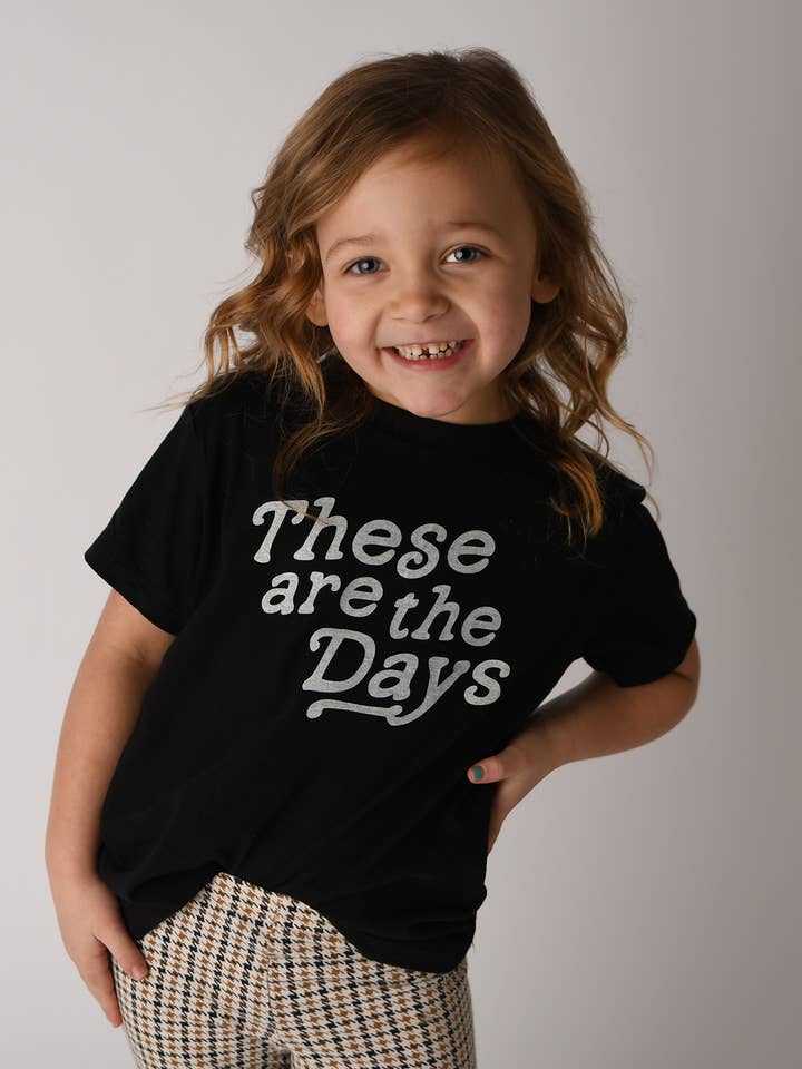 These are the Days Kids' Tee - Black with White Lettering for wholesale by Storied Folk & Co.