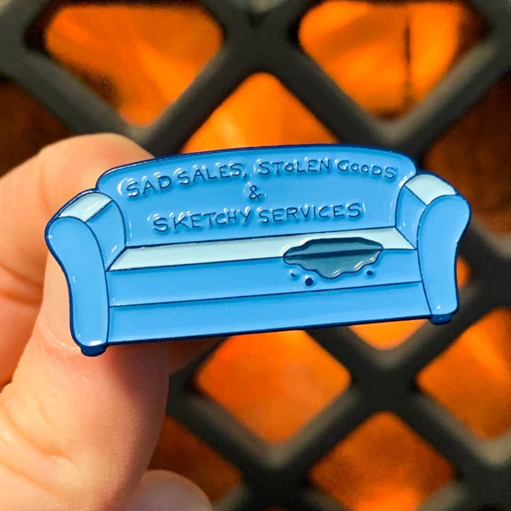 Sad Sales Squirted Couch Enamel Pin for wholesale by The Roving House