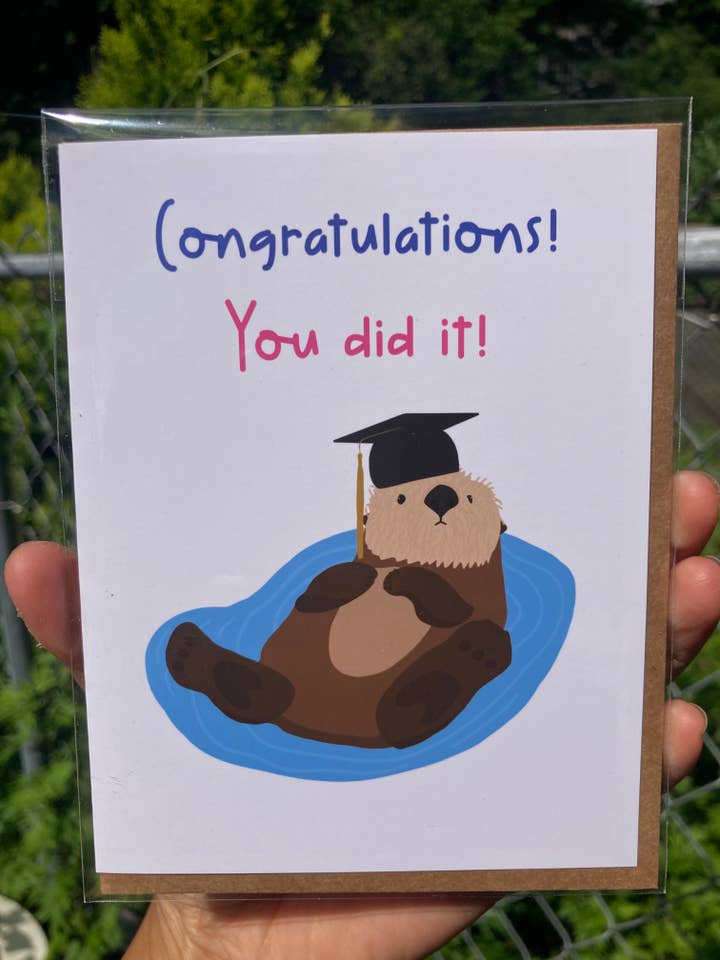 Graduation Otter Greeting Card - Congratulations! You Did It for wholesale by Jenn L Design