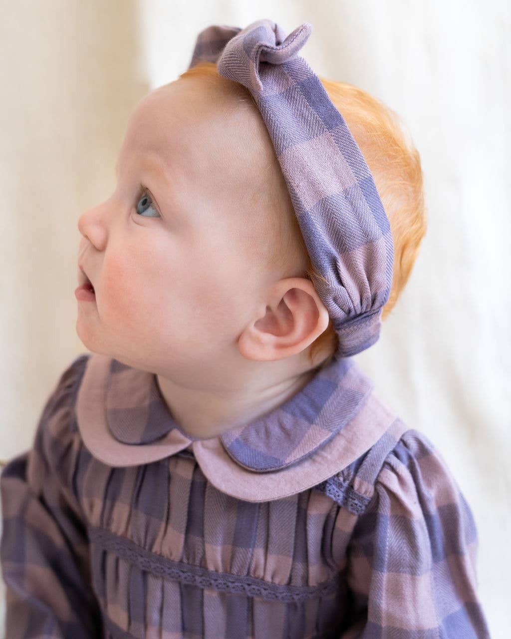 Lilac Smocked Peter Pan Gingham Baby Romper (Organic) for wholesale on Faire7