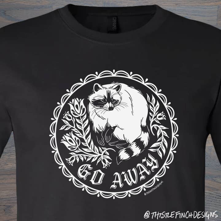Go Away Raccoon Hex Sign Unisex T-Shirt for wholesale by Thistle Finch Designs