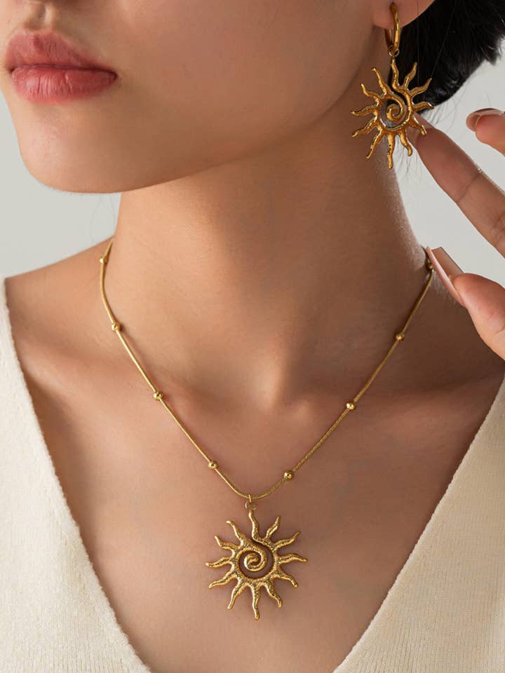 Golden Spiral Sun Necklace in Stainless Steel for wholesale by COSMOS