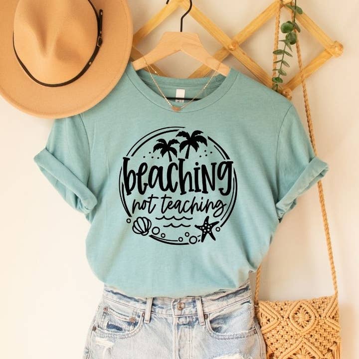Beaching Not Teaching Dusty Blue Tee Black Ink for wholesale by Simply Tees