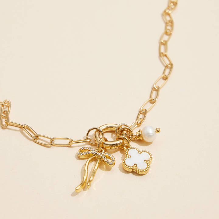 Gold Dipped Bow Charm Necklace with Clover and Pearl for wholesale on Faire