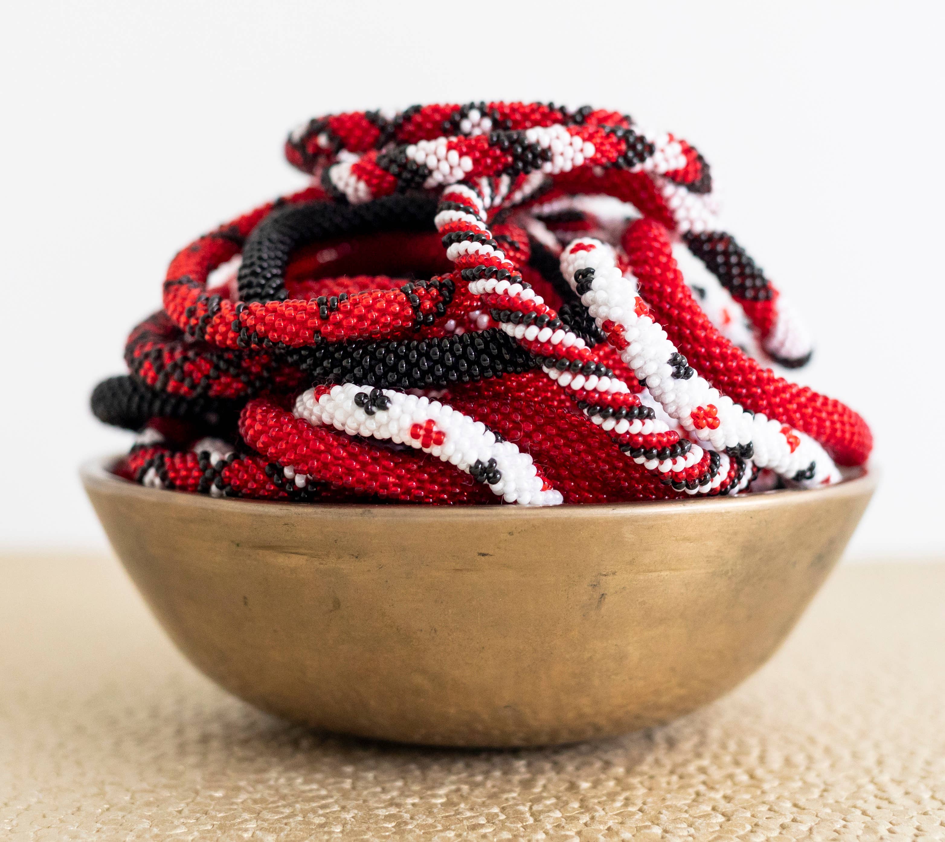 Aid Through Trade - Wholesale Jewelry Set - Roll-On® Game Day Bracelets Red, Black and White - Set of 121