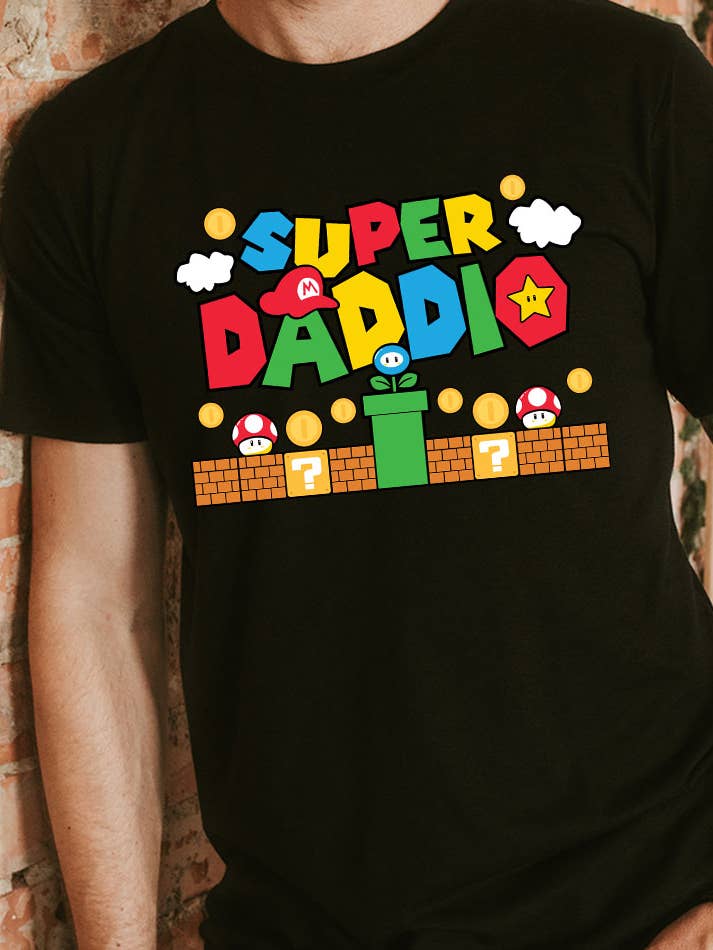 Black Super Daddio Dad - Video Game Father's Day T-Shirt for wholesale on Faire