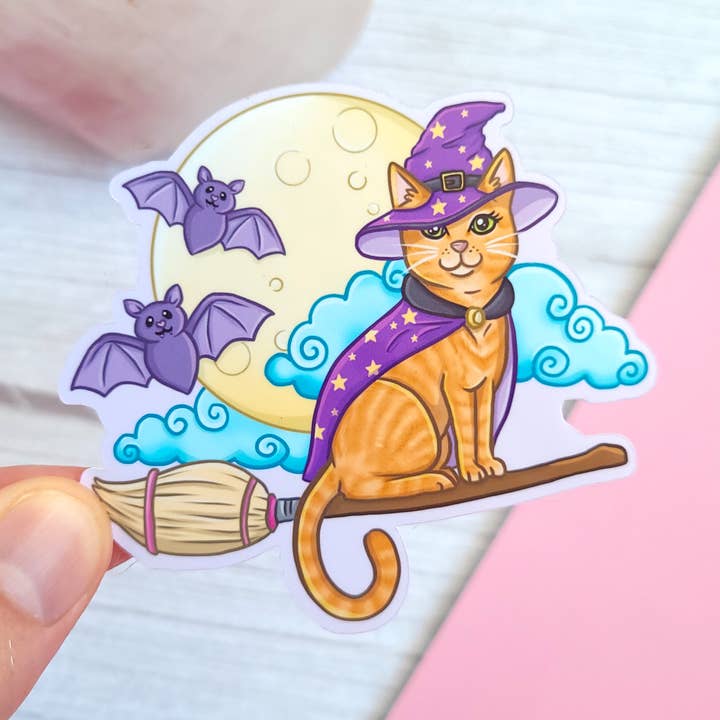 Witch Broom Orange Cat Vinyl Sticker, 3x2.7" for wholesale by Chez Louie Designs