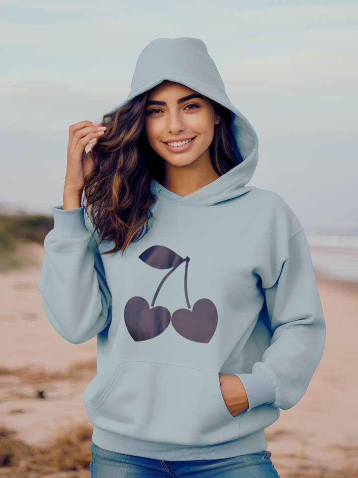 Sweetheart Cherries Hoodie – Light Blue Pullover with Heart-Shaped Cherry Graphic for Cute Cozy Style for wholesale by The Maximalist Boutique